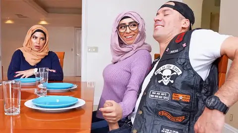 Hijab-wearing girl giving a hj from under the table