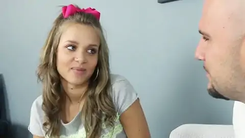 Platinum-blonde teenage with smallish boobs chatting to a shaven boy