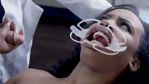 Medic screws face of astonished patient in the health center